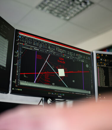 Expert Cteam analysant des schémas techniques complexes et des données sur des moniteurs. Expert Cteam analysant des schémas techniques complexes et des données sur des moniteurs.